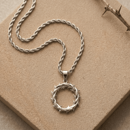 Silver Crown of Thorns Necklace displayed on beige fabric